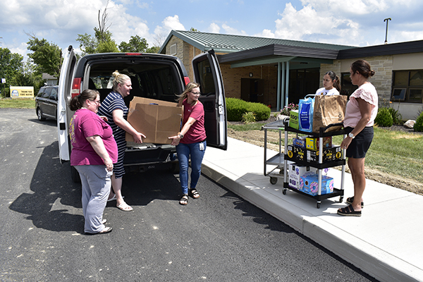 Buchanan team carries donated items for Scott Academy