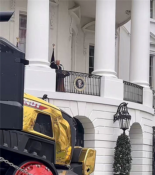 President Trump takes a moment to admire the gold tractor that Buchanan Logistics, Inc. transported to the White House.