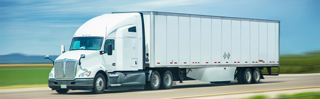 Dry van tractor-trailer carrying packaged food and beverage freight for commercial distribution.