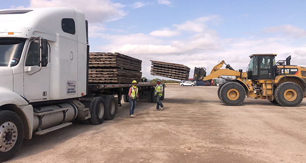 Flatbed trailer transporting structural and construction materials for a commercial freight shipment. Flatbed trailer transporting structural and construction materials for a commercial freight shipment.