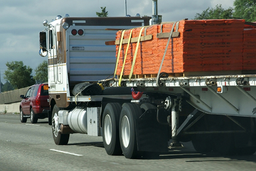 Building products arriving by semi-truck for a scheduled commercial jobsite freight delivery. Building products arriving by semi-truck for a scheduled commercial jobsite freight delivery.