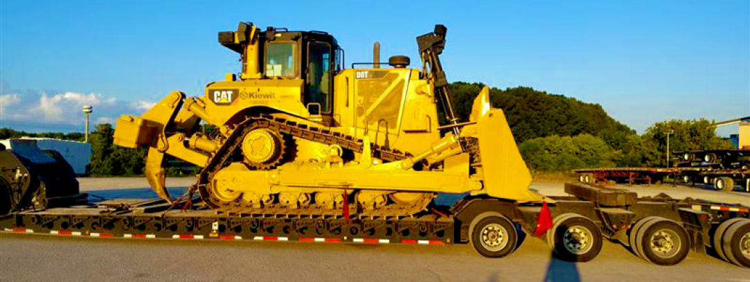 Buchanan Logistics uses their heavy haul trailer to transport a bulldozer, construction equipment and materials to a jobsite.