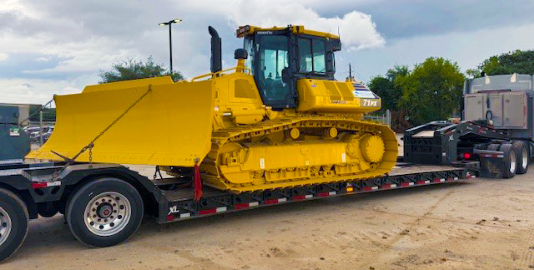 Buchanan Logistics uses their heavy haul trailer to transport a bulldozer, construction equipment and materials to a jobsite.