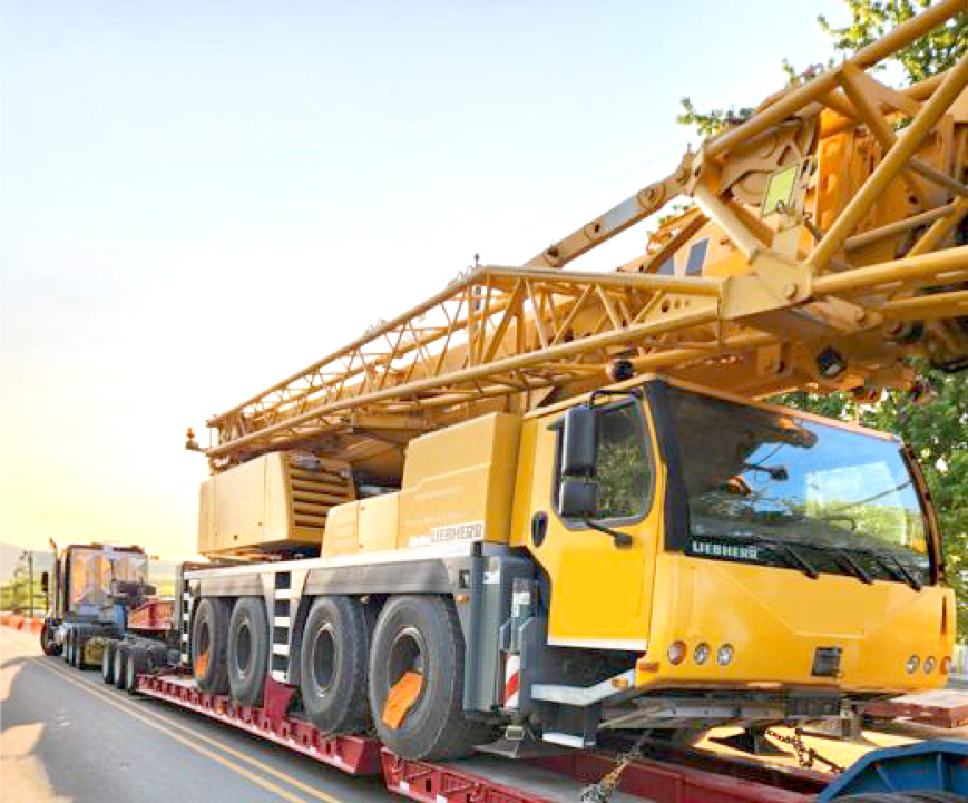 Buchanan Logistics transporting a mobile crane to a jobsite for a construction crew.