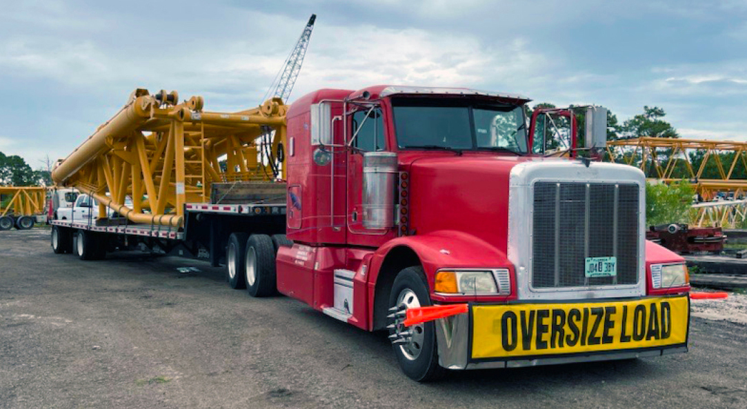 Buchanan Logistics transporting a crane part to a jobsite for a construction crew.