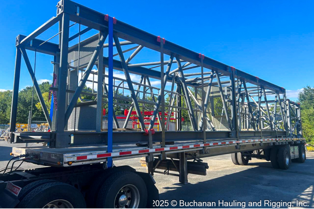 Buchanan Hauling and Rigging transports a tower crane to a construction jobsite.
