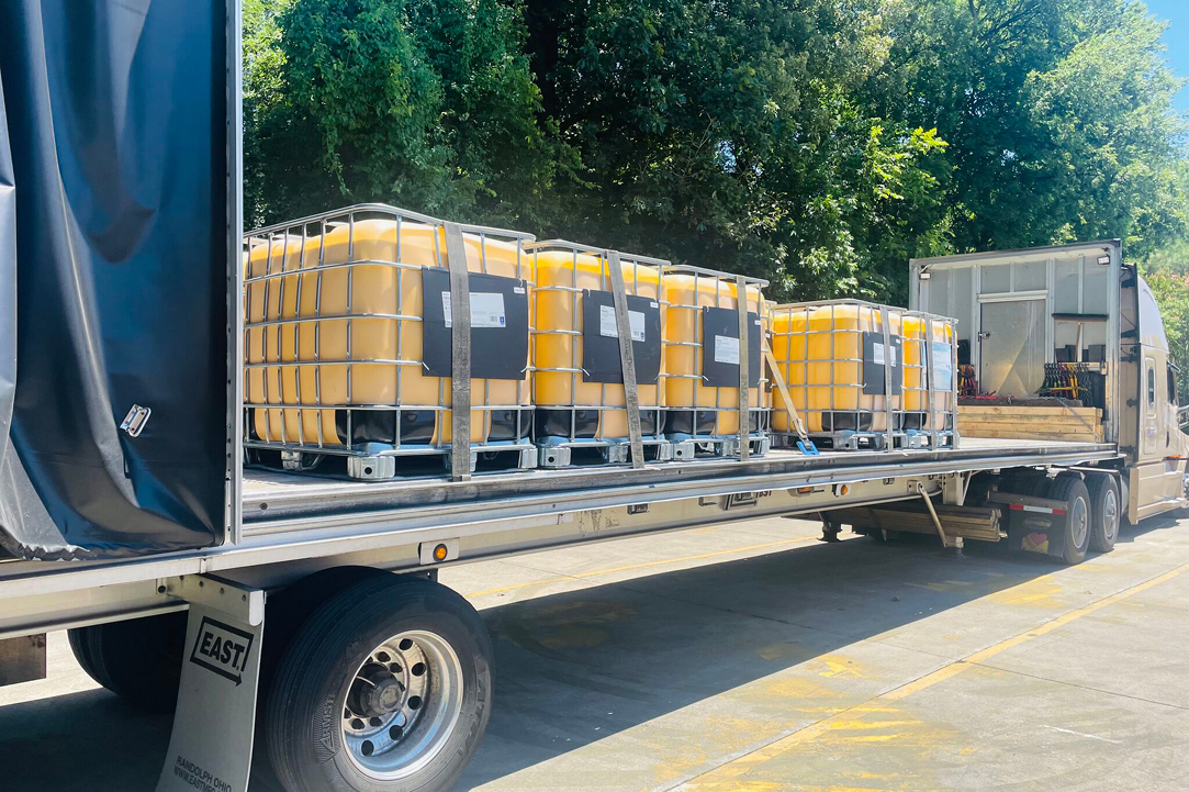 Buchanan Logistics transporting freight to a retail chain with their Conestoga curtainside flatbed trailer.
