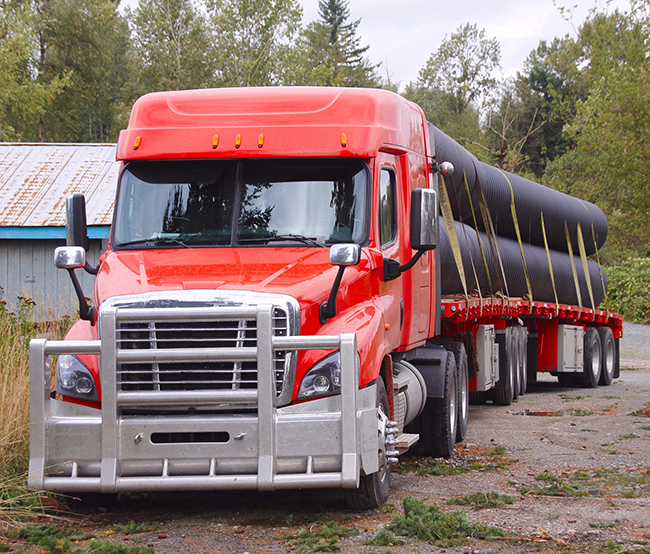 A driver readies his truck to deliver freight loaded on his flatbed for Buchanan Logistics.
