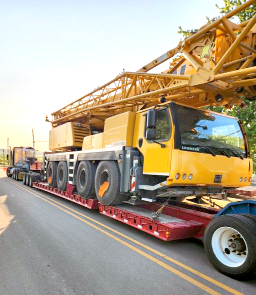 Buchanan Logistics moving a mobile crane to a construction jobsite with their heavy haul trailer.
