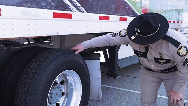 Kentucky officer reviews a trailer for tire wear.
