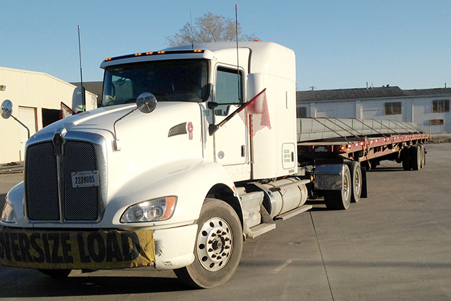 Buchanan Logistics, Inc. transports steel for a customer with their flatbed trailer.