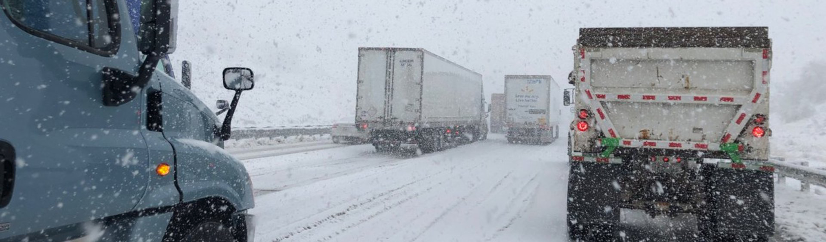 Semi trucks driving in winter.