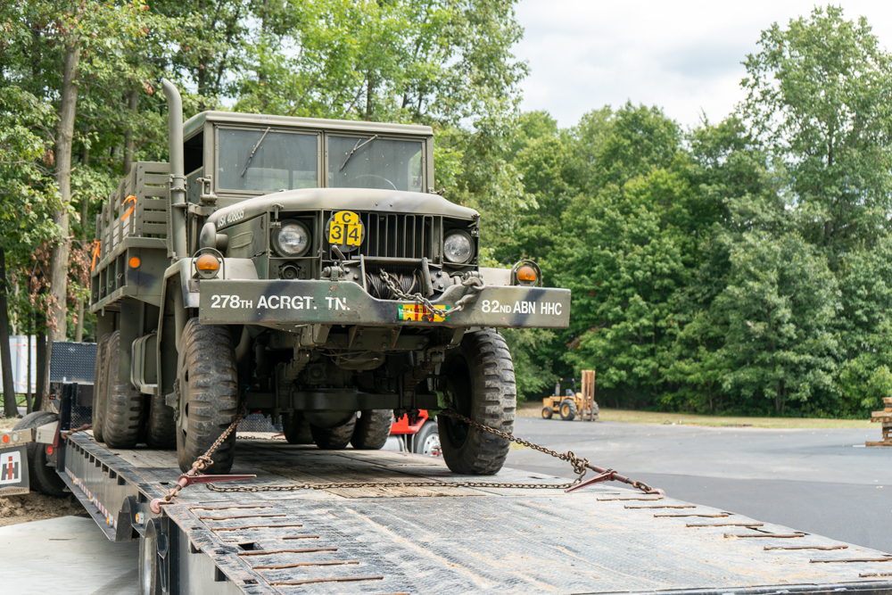 Military vehicles being loaded onto a Buchanan Hauling truck for transport.